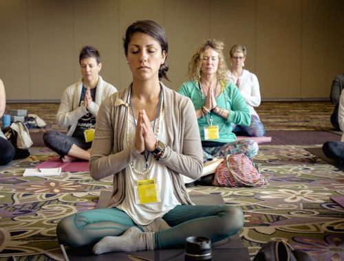 Women doing a seated yoga pose.