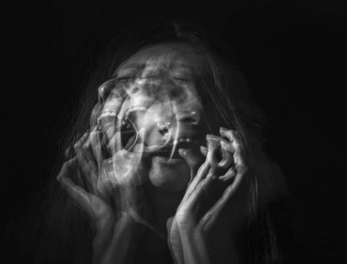 Screaming woman with a blurred face.