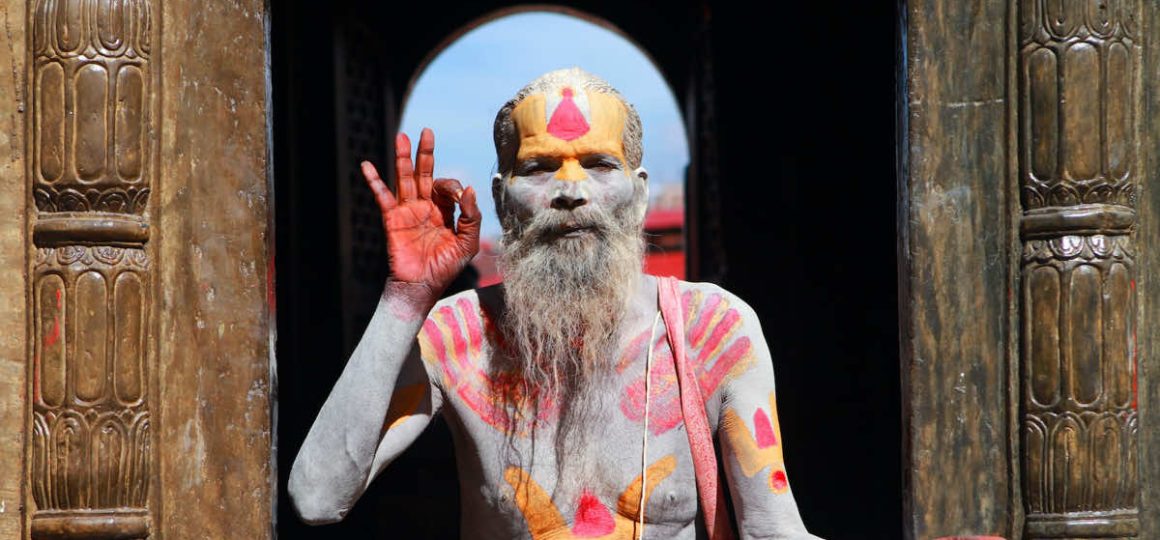Hindu yogi sitting on temple steps.