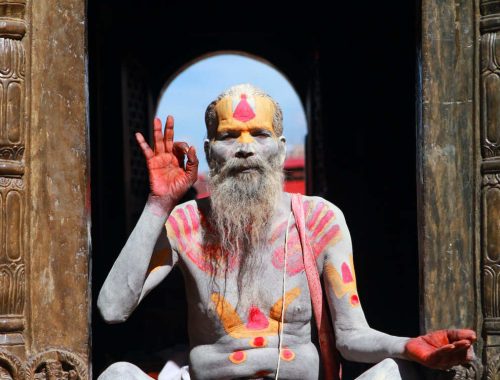 Hindu yogi sitting on temple steps.